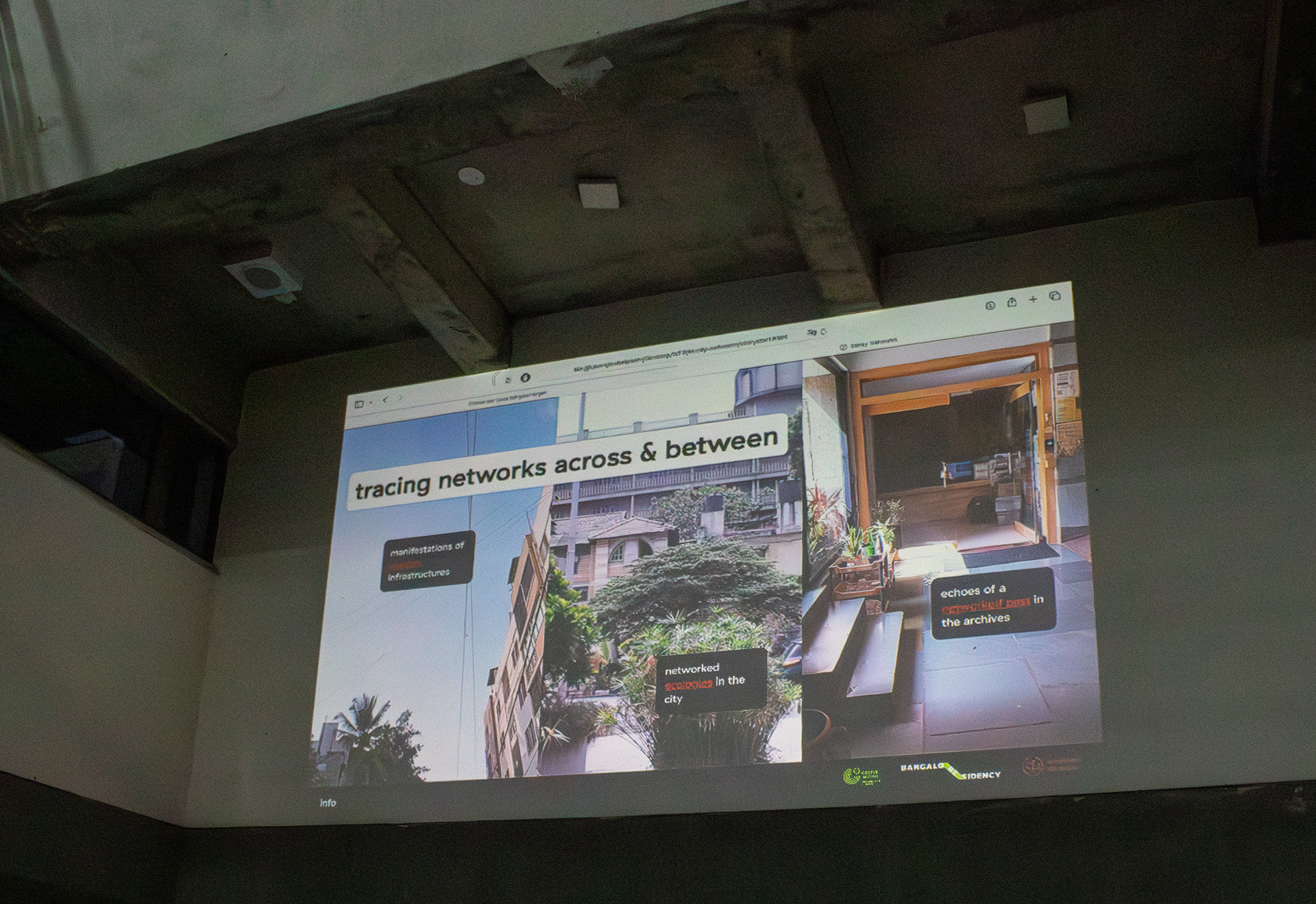 A browser shows a website that is split into 3 thirds horizontally with a header saying: tracing networks across & between. The left part shows a view up into the sky with electric cables, a streetlight, buildings, and the text: manifestations of internet infrastructure. The center shows a lush area with a big building in the background and the text: networked ecologies in the city. The right one shows the inside of a library foyer with the text: echoes of a networked past in the archives. In the texts, some parts of the text are marked as hyperlinks.